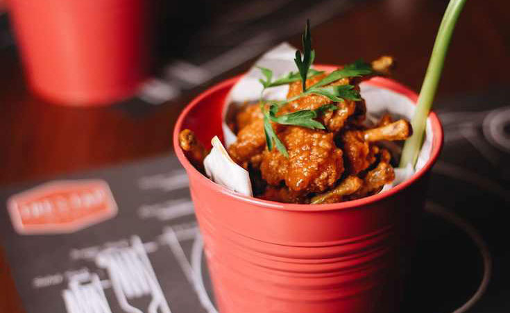 The Tap's New Weeknight Hungry Hour Will Leave You Up to Your Knees in Chicken Wings